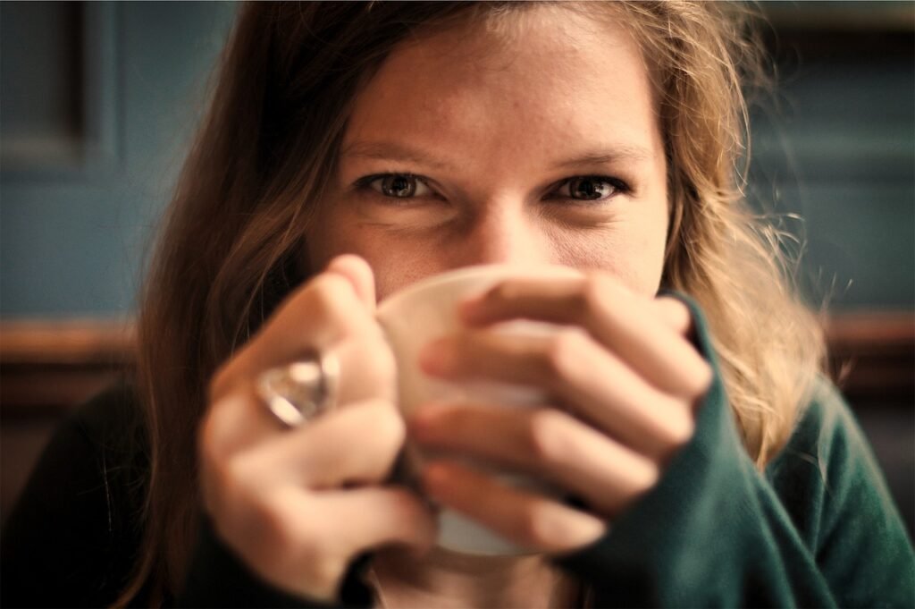 girl, woman, smile, smiling, happy, coffee, tea, cup, drinking, eyes, people, cozy, comfortable, relaxed, coffee cup, sipping, brown coffee, brown happy, brown relax, brown tea, tea cup, brown smile, brown eye, brown happiness, brown cup